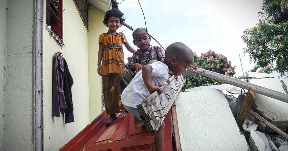 Rohingya children play amongst the rubble where their school once stood